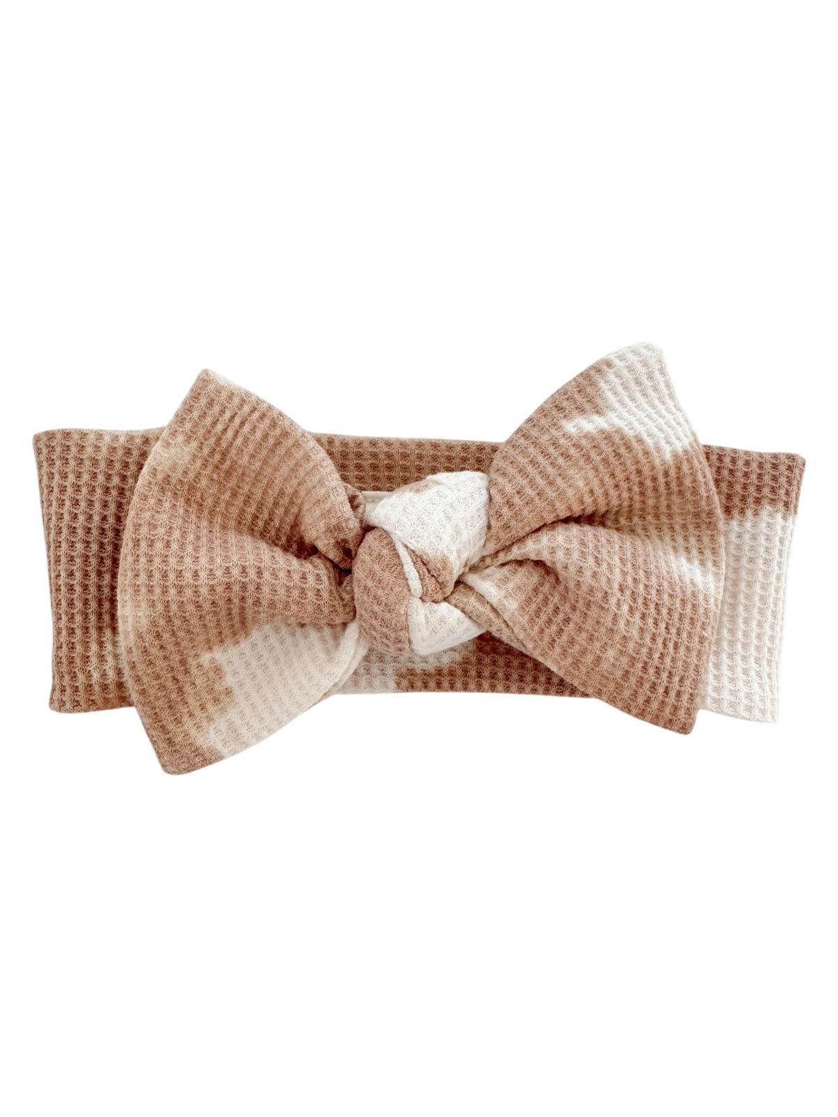 Brown and white patterned headband with a large bow design, made of soft textured fabric.