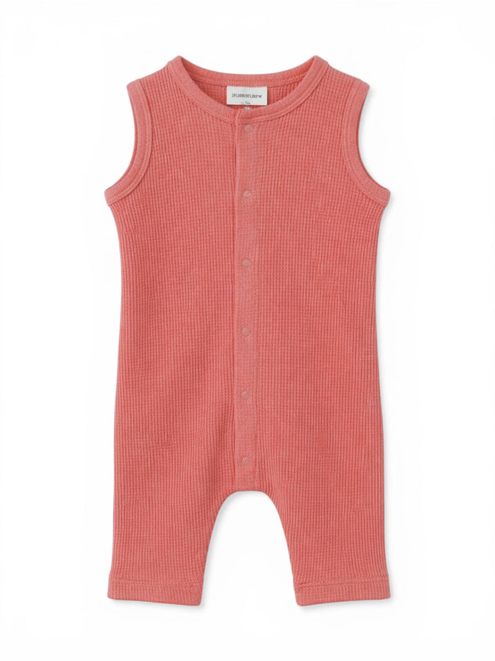 Coral sleeveless baby jumpsuit with front buttons and ribbed texture, ideal for warm weather outfits.