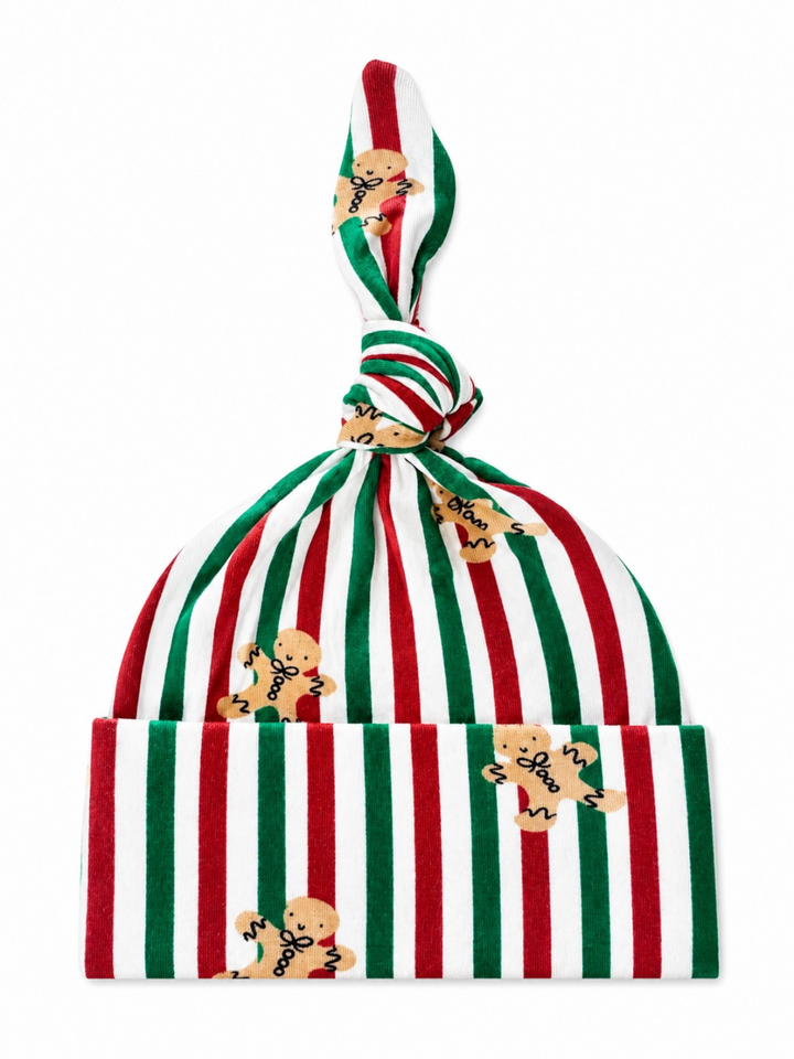 Red and green striped hat with gingerbread man patterns and a knotted top. Ideal for holiday celebrations.