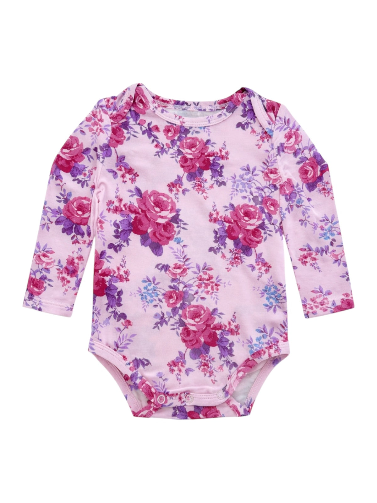 Pink floral long-sleeve baby bodysuit with purple and red roses on a soft fabric background.