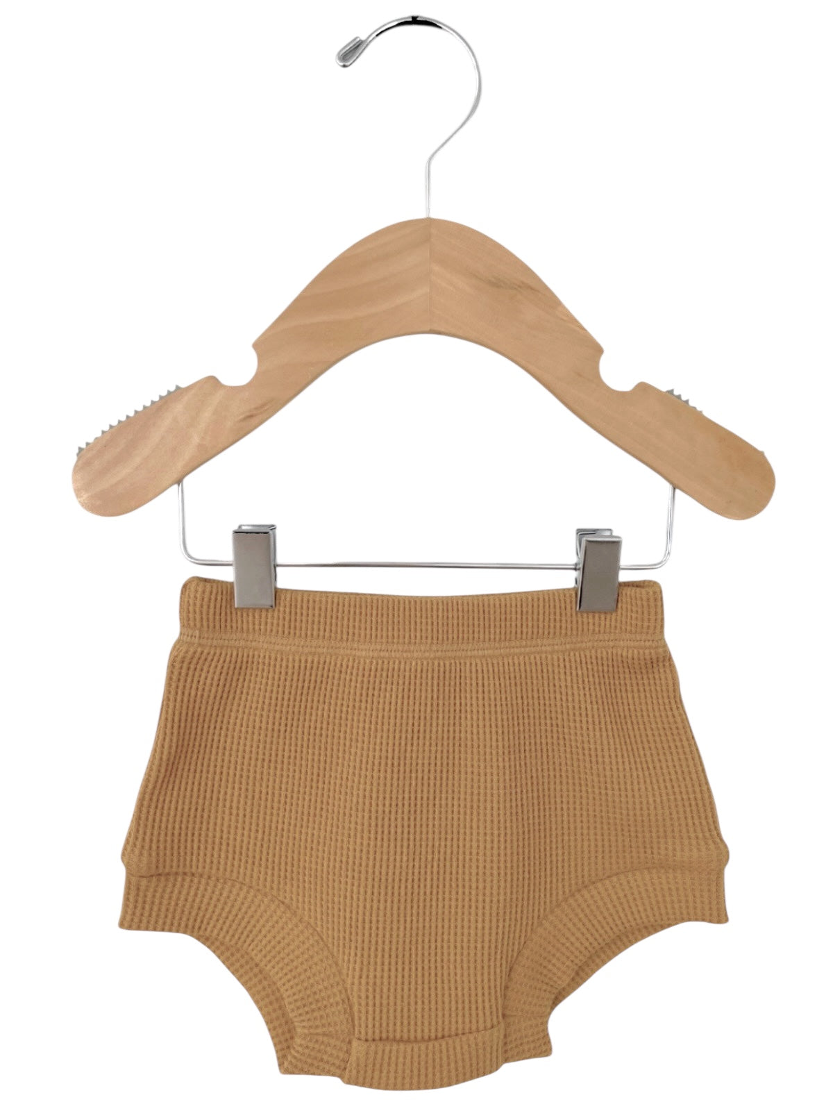 Tan ribbed toddler shorts hanging on a wooden hanger against a white background.