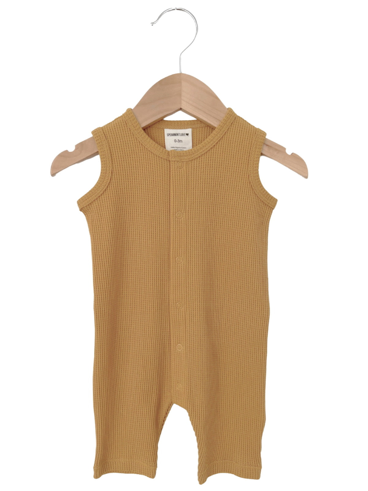 Yellow ribbed baby romper on a wooden hanger, size 0-3 months.
