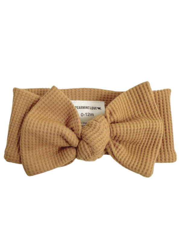 Tan baby headband with a knot, suitable for infants 0-12 months, by Spearmint Love.