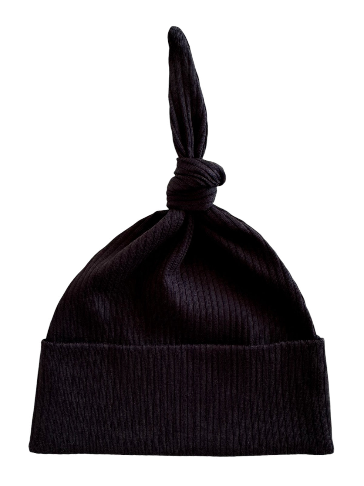 Black ribbed beanie hat with a unique knot at the top, ideal for winter fashion.