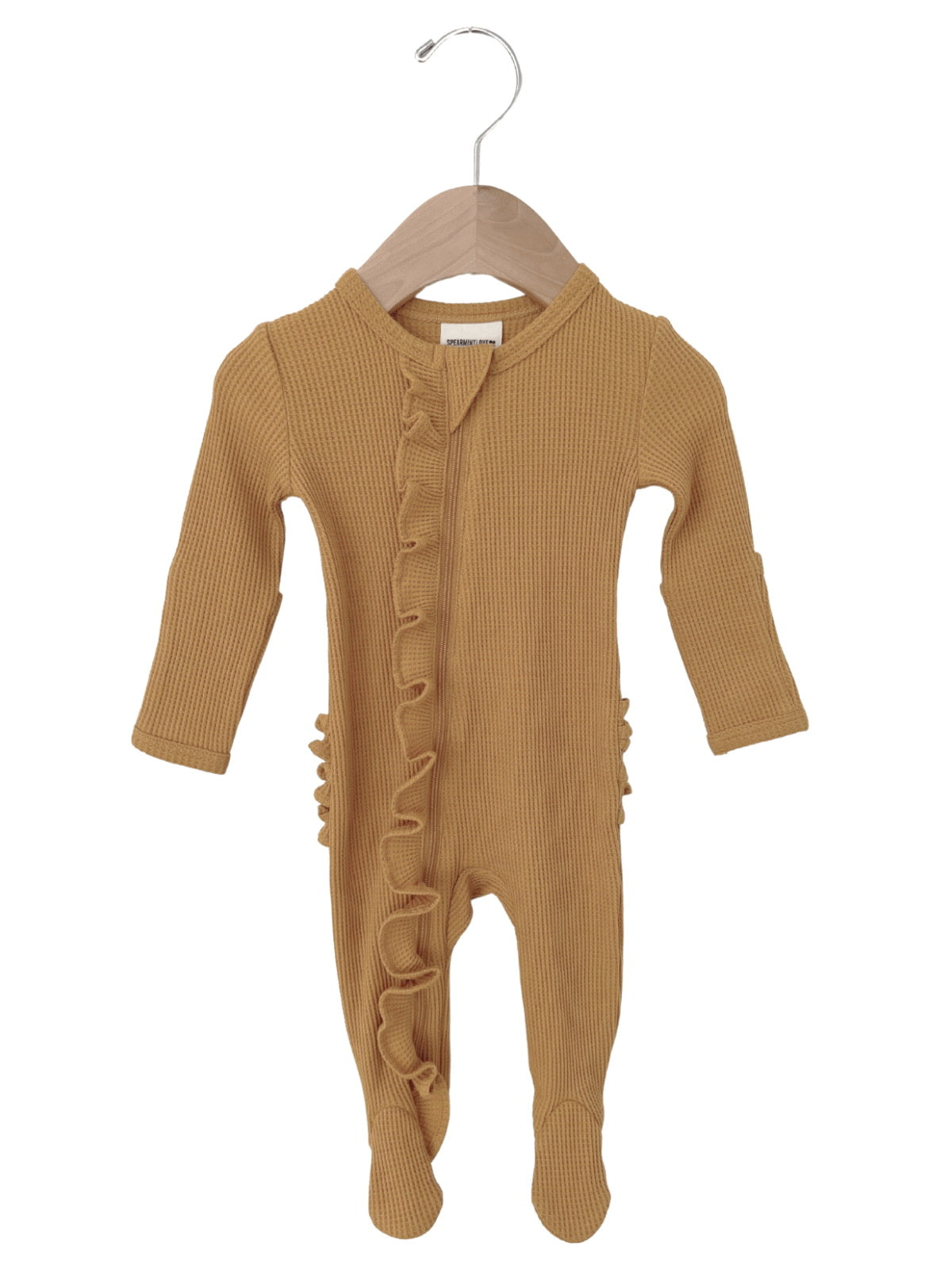 Mustard yellow ribbed baby onesie with ruffles, hanging on a wooden hanger.