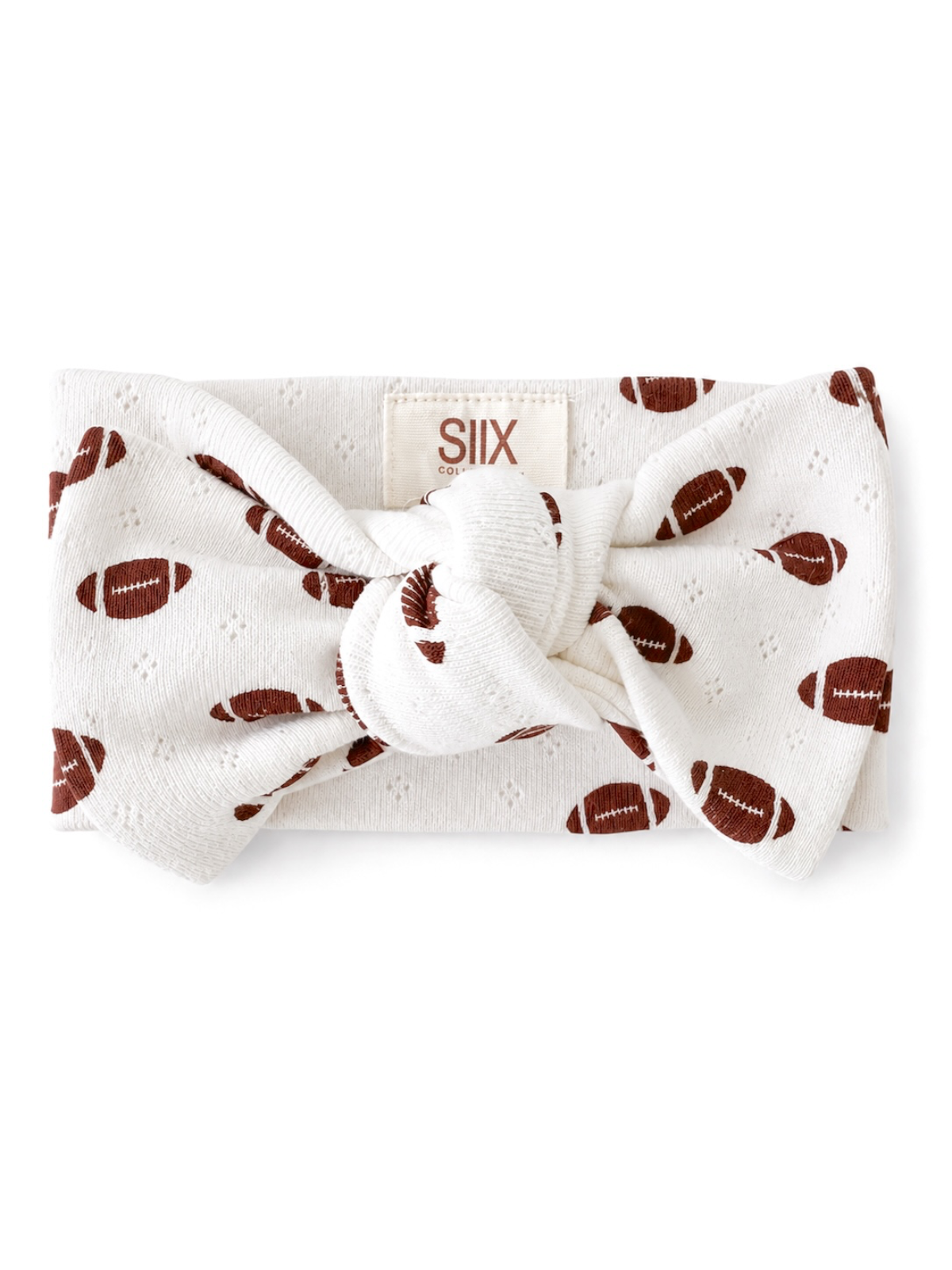 White headband with football pattern and knot detail, labeled with brand SIIX.