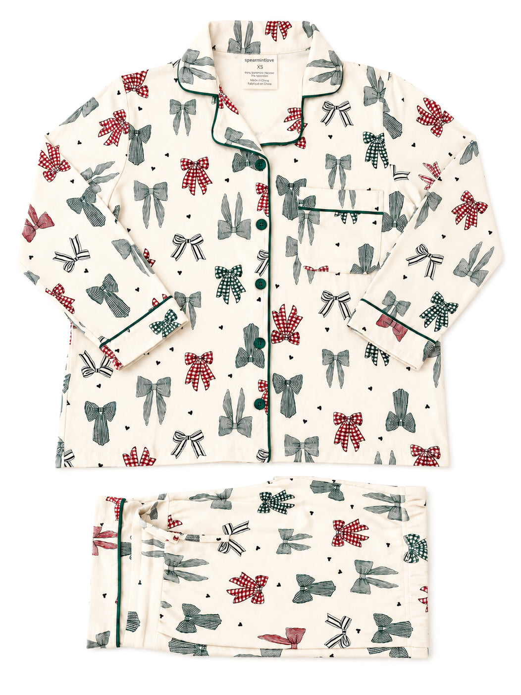 Pajama set featuring a playful bow pattern in red, green, and black on a cream background, with green trim details.