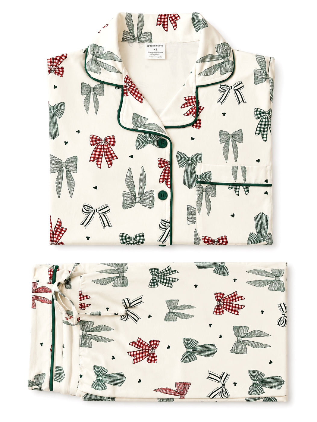 Cream pajama set featuring a pattern of bows in red, green, and black on a light background.