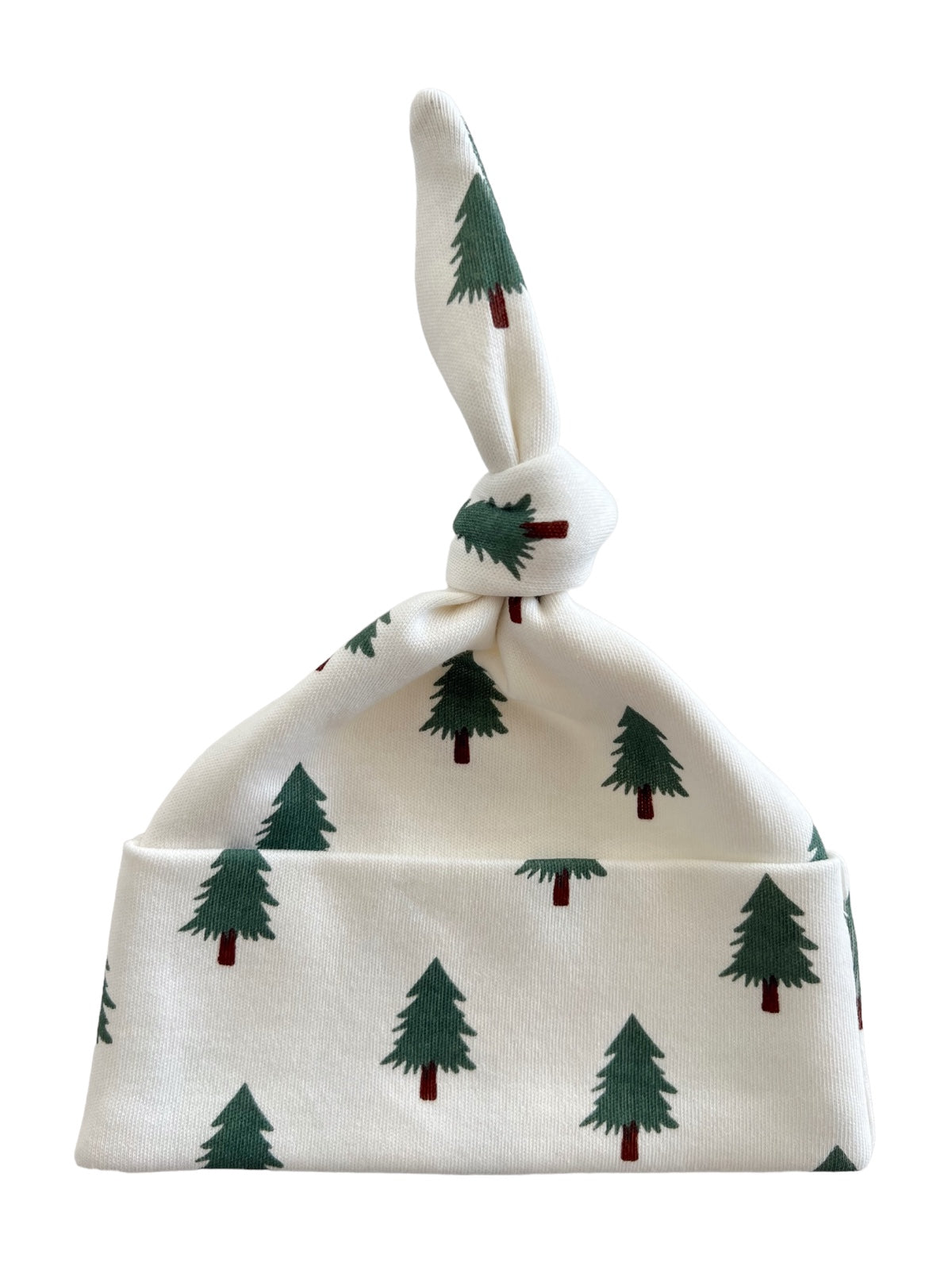 White baby hat with a knotted top, featuring a green tree print throughout. Ideal for winter wear.