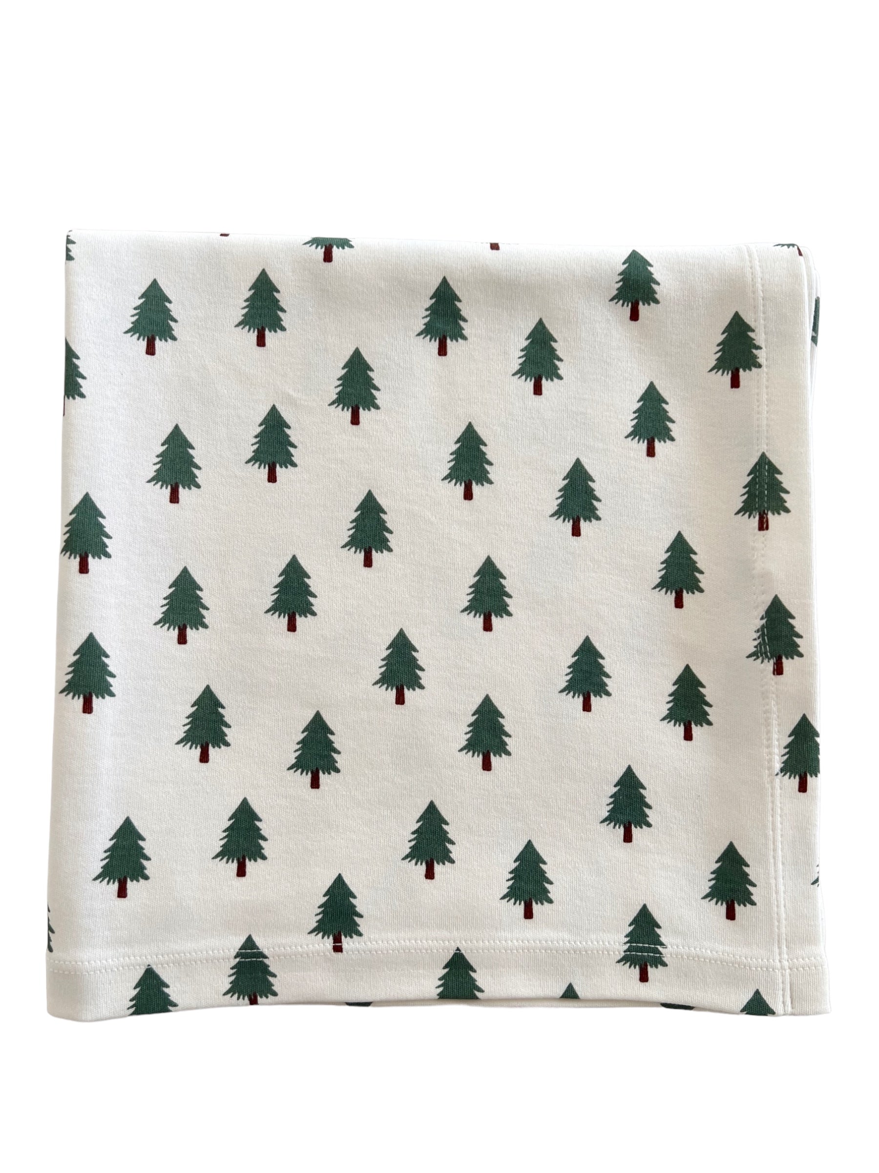 Fabrics with a repeating pattern of green pine trees on a cream background. Perfect for holiday decor.