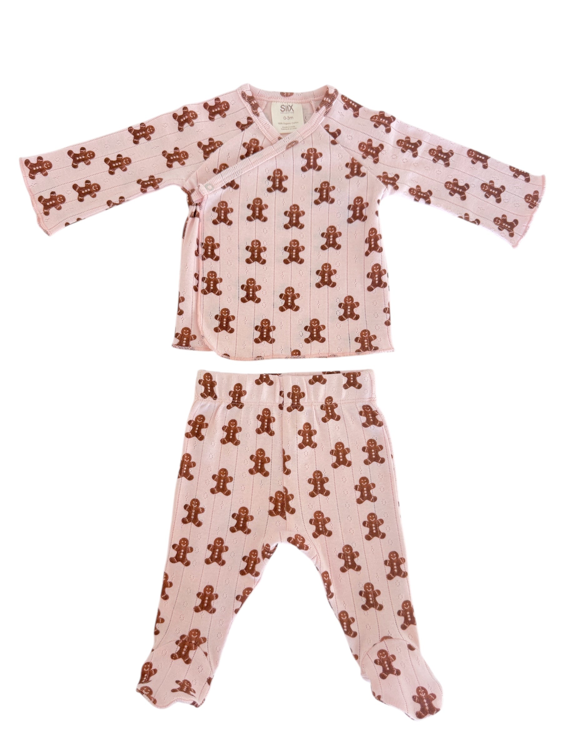 Pink toddler pajama set featuring a gingerbread man print on both the top and pants.