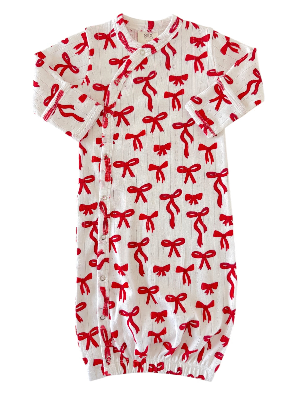 Baby gown with red bow pattern on white background, featuring short sleeves and a gathered bottom.