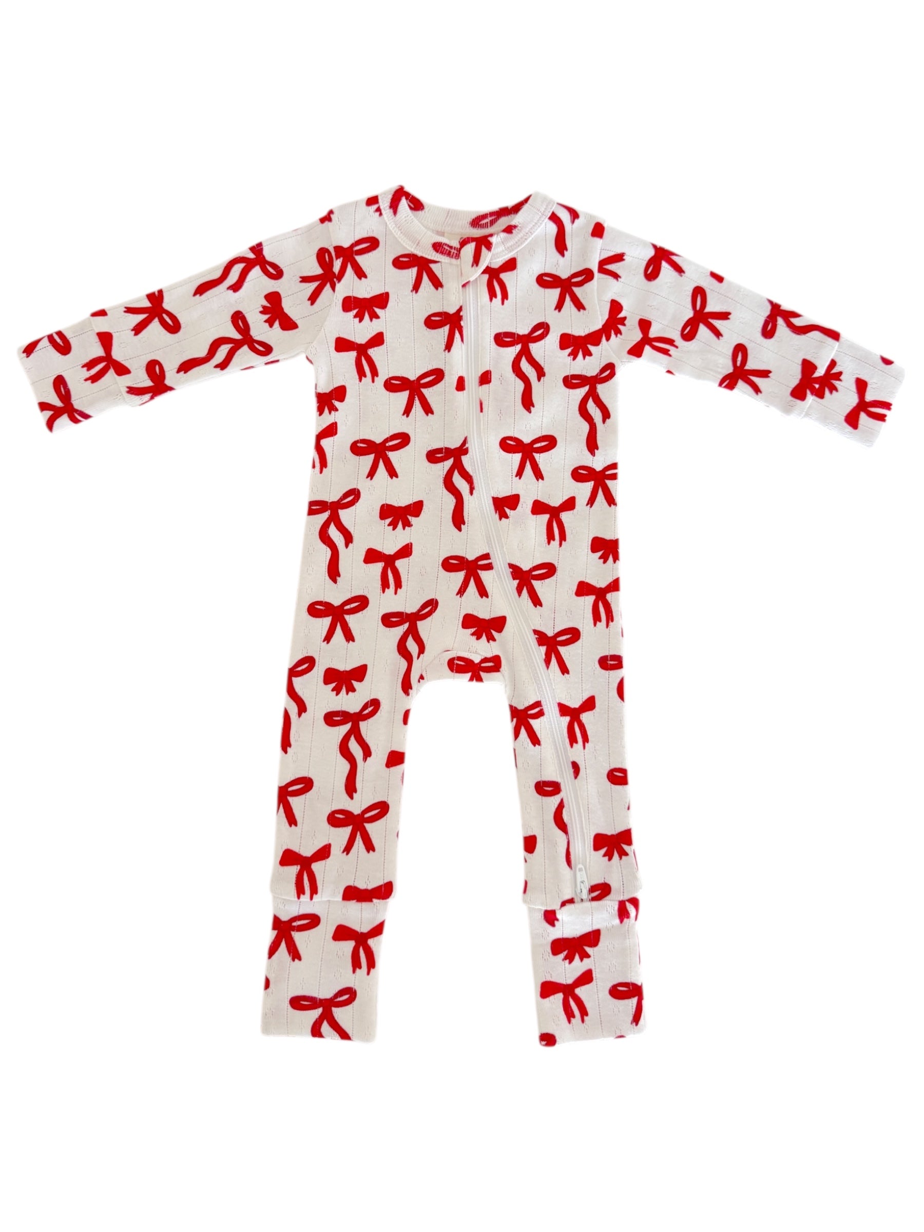 White baby onesie with red bow print, featuring long sleeves and a front zipper.