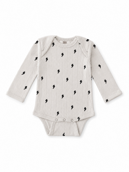 Gray long-sleeve baby onesie with black lightning bolt pattern and snap closure at the bottom.