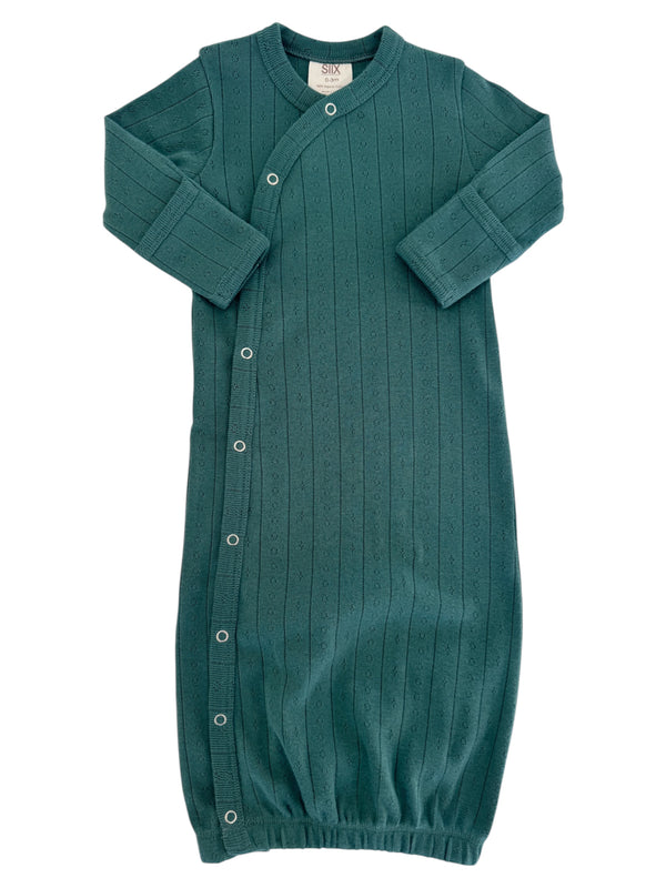 Teal baby gown with long sleeves and snap closures, featuring a ribbed texture and gathered hem.