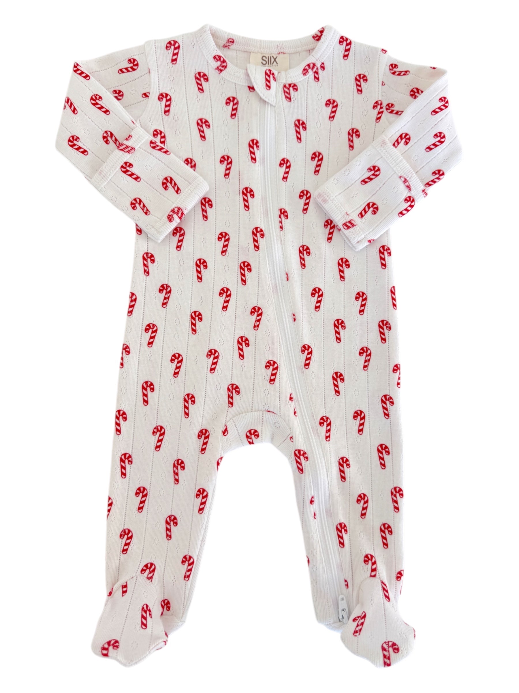 White pajama onesie with red candy cane print, featuring long sleeves and a zipper. Perfect for holiday sleepwear.