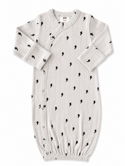 Light gray baby gown with black lightning bolt pattern, featuring snap buttons and elastic bottom for easy dressing.
