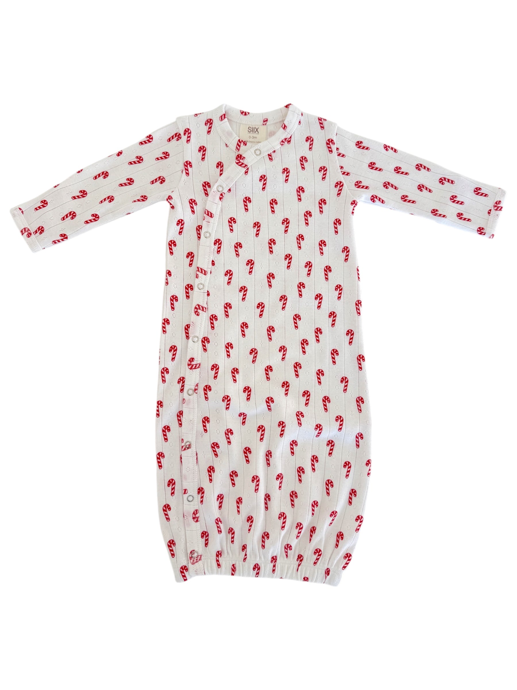 White baby gown with red candy cane pattern and button closures, perfect for cozy holidays.