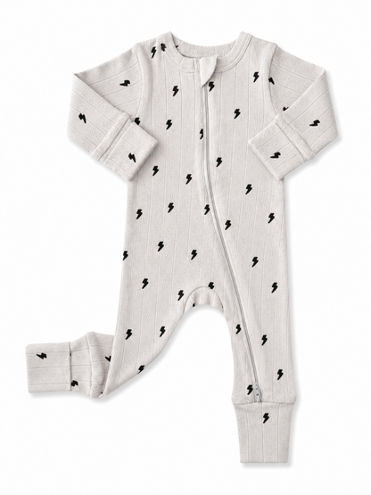 Light gray baby onesie with black lightning bolt patterns and a front zipper. Ideal for comfort and style.