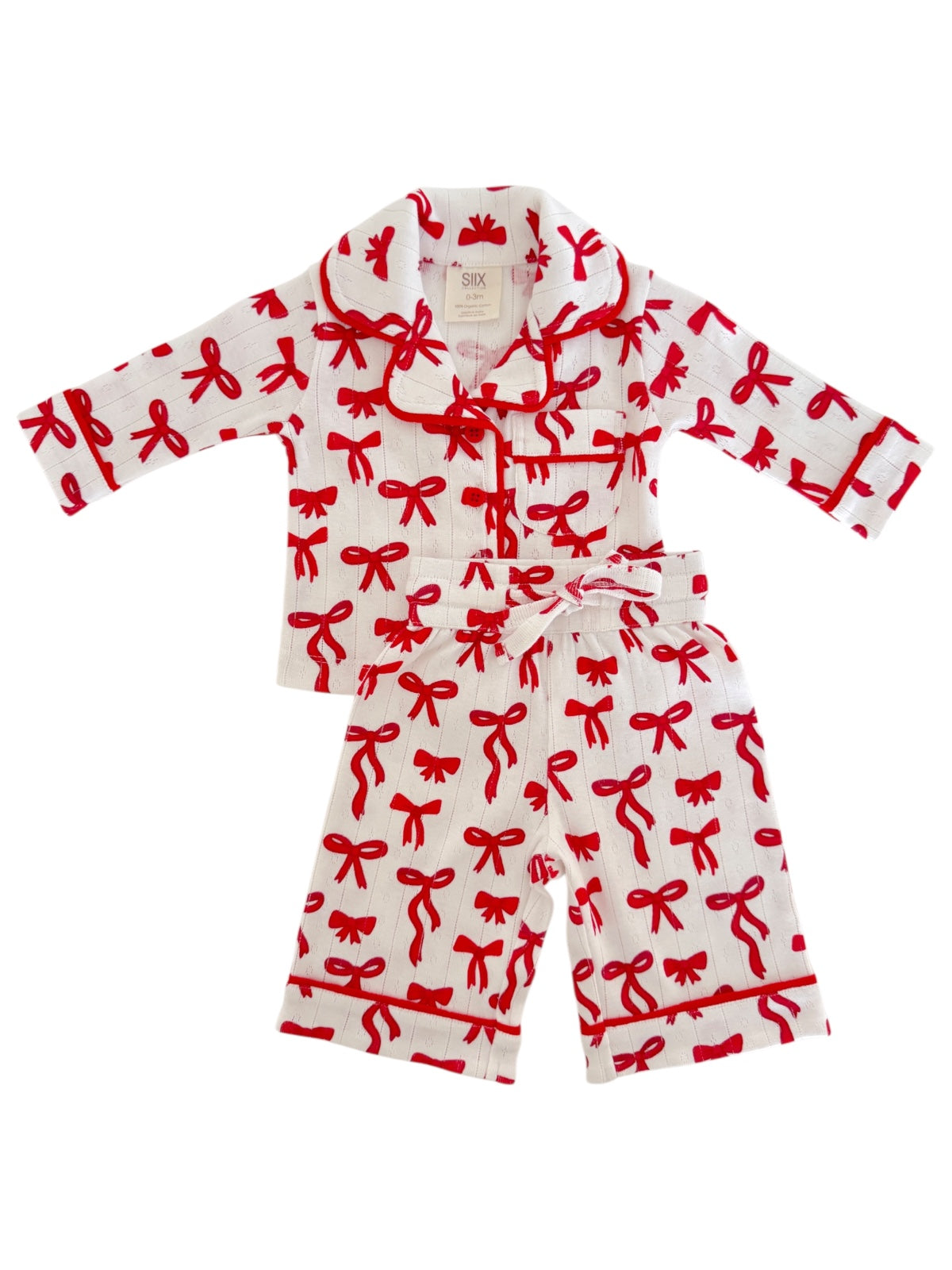 Red bow pattern cotton children's pajama set including a long-sleeve top and matching pants.