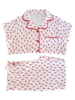 Red and white candy cane patterned pajama set featuring a short-sleeve top and shorts.