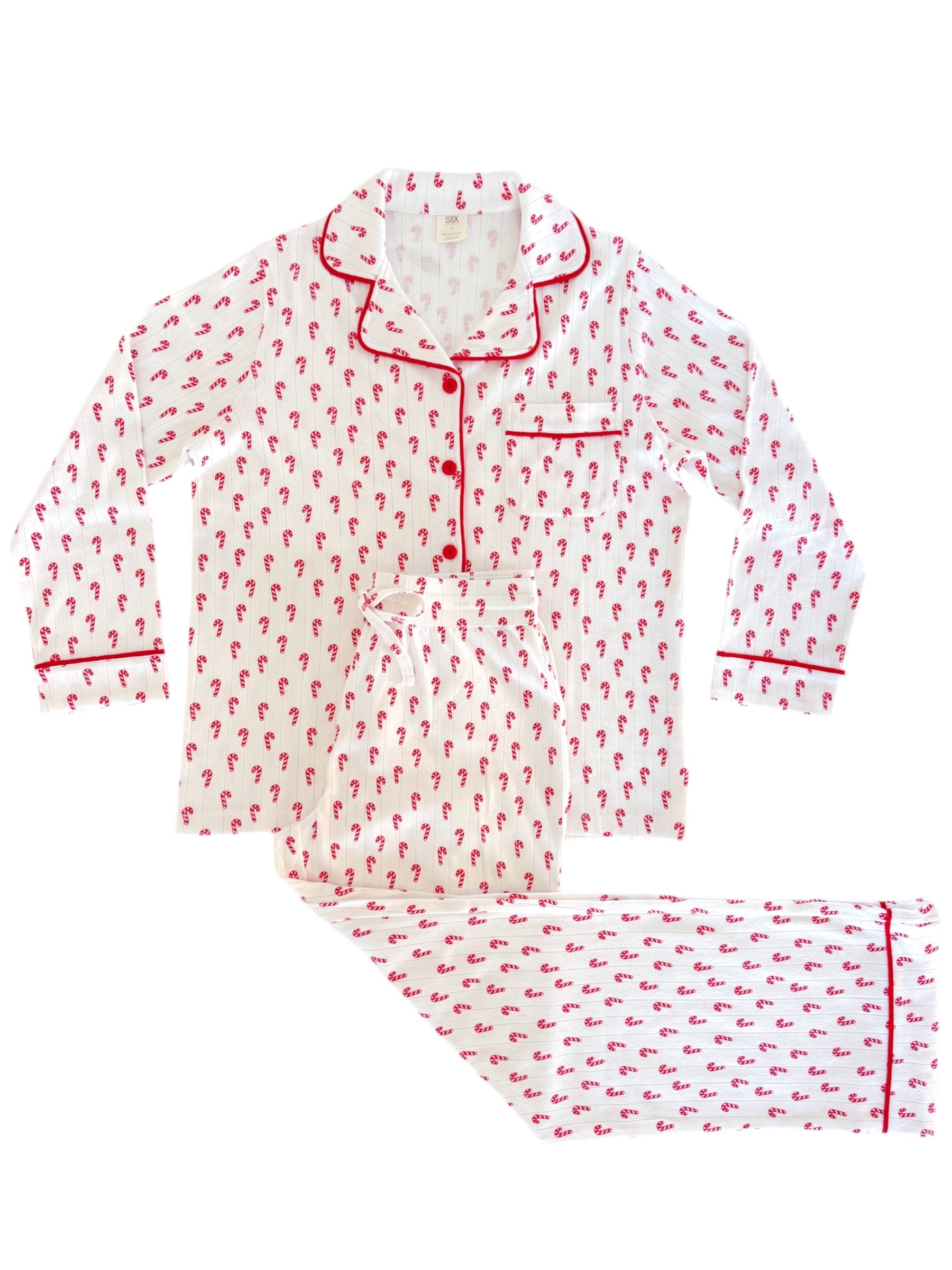White pajama set with red candy cane print and trim, featuring long sleeves and matching pants.