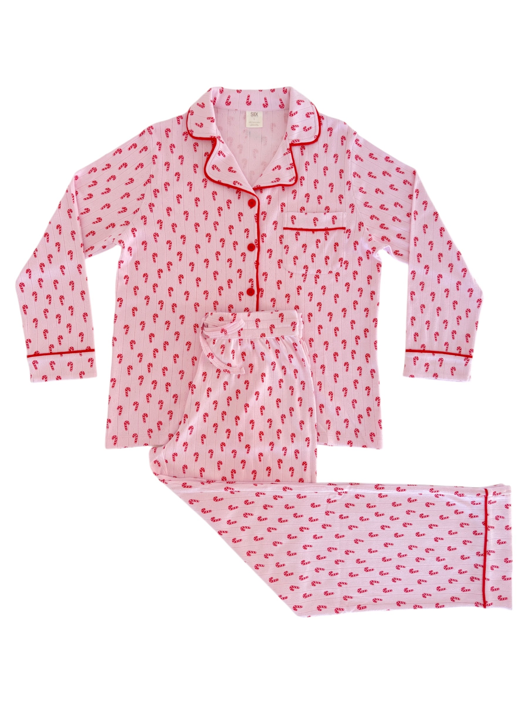 Pink pajama set with red candy cane pattern, featuring a button-up top and matching pants.