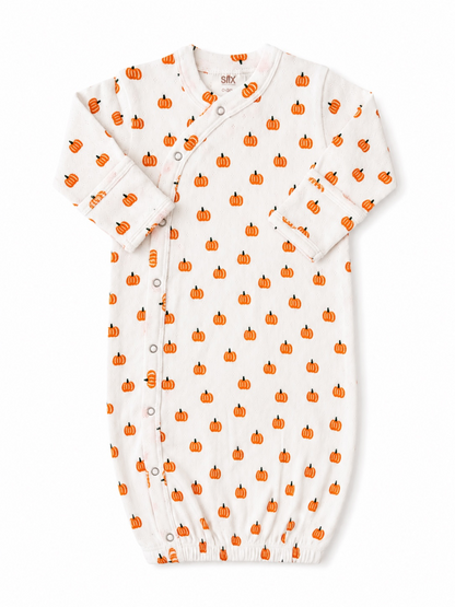 White baby gown featuring a playful pumpkin pattern in orange and black. Perfect for fall-themed outfits.