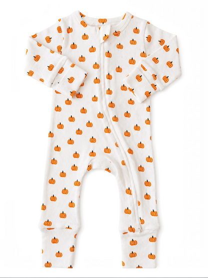 White pajama onesie with orange pumpkin prints, featuring long sleeves and a front zipper closure.