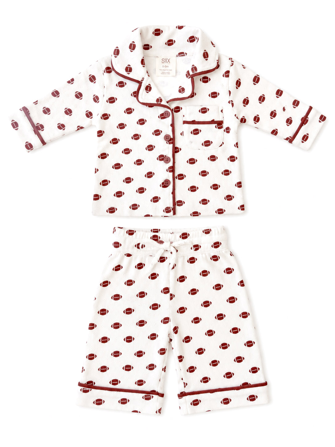 Kids' white pajama set with football print, featuring a button-up top and elastic waist shorts.