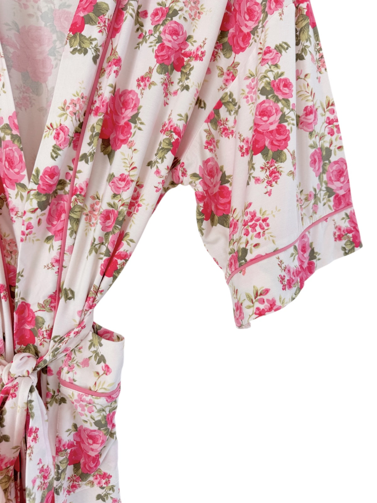 Floral women's robe featuring pink roses on a white background, with loose sleeves and a tied waist.