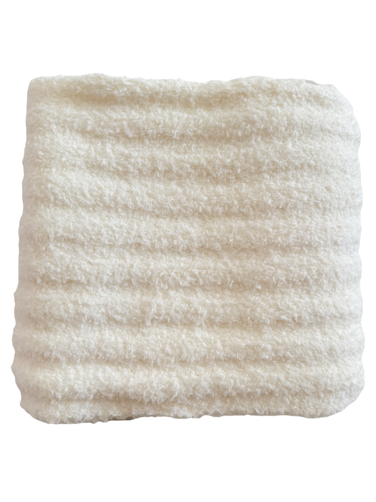 Soft, cream-colored blanket with a textured, ribbed pattern.