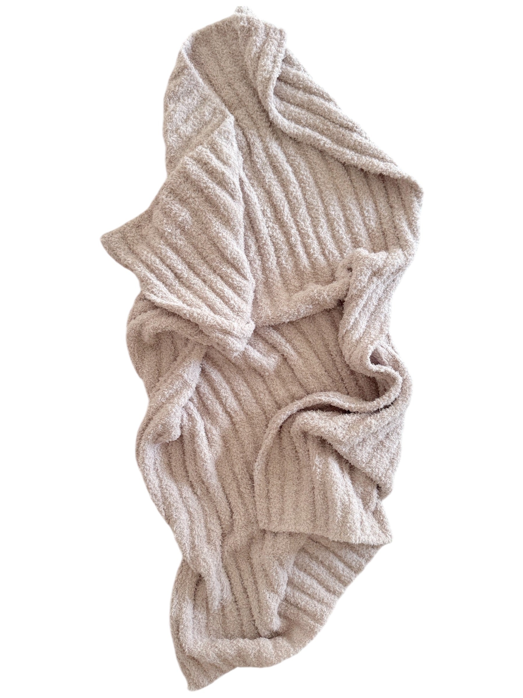 A soft, ribbed beige blanket draped artistically on a white background.