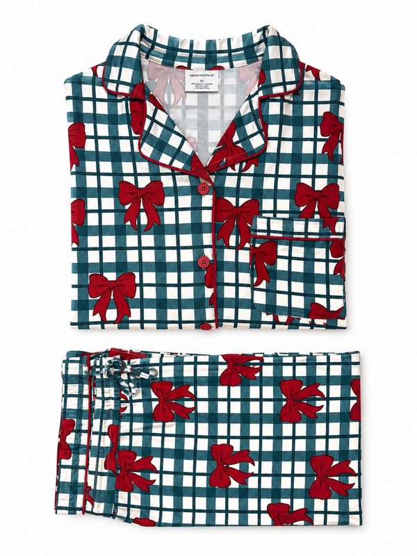 Green and white checkered pajamas with red bows, featuring a button-up top and matching pants.
