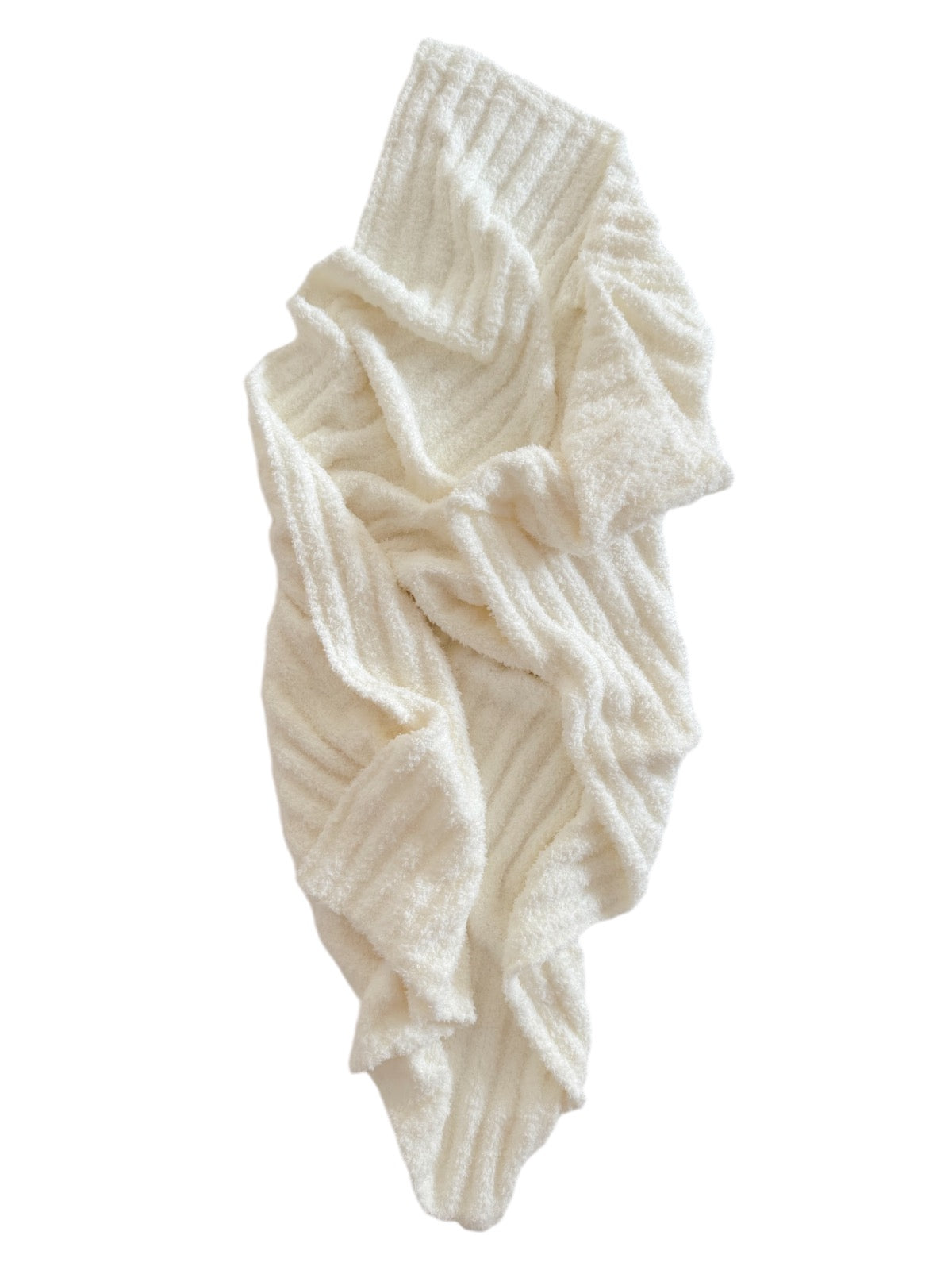 Soft, white knit blanket draped elegantly, showcasing a cozy texture and gentle ribbed pattern.