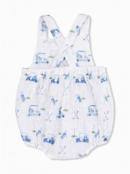 Children's romper with a blue golf cart pattern on a white background, featuring crossed straps and gathered waist.