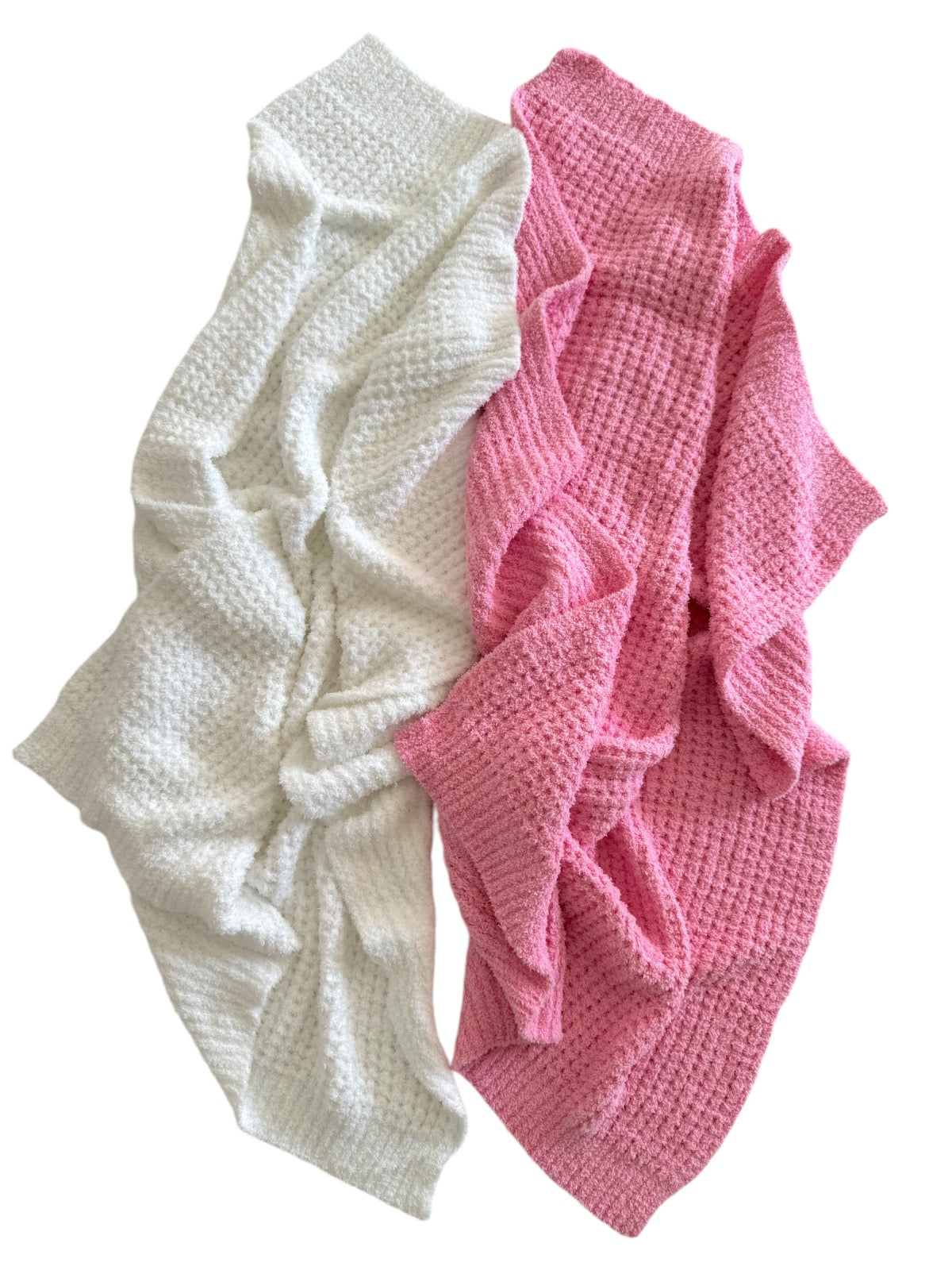 Two cozy blankets, one white and one pink, laid out with a textured pattern. Perfect for comfort and decoration.