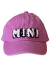 Pink baseball cap with fluffy "MINI" text stitched on the front.