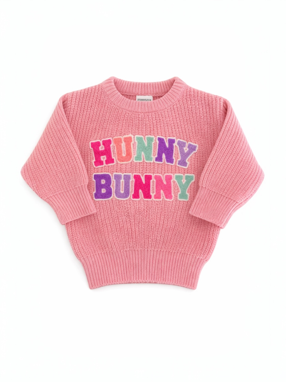 Pink knitted sweater with the words "HUNNY BUNNY" in colorful, block letters.
