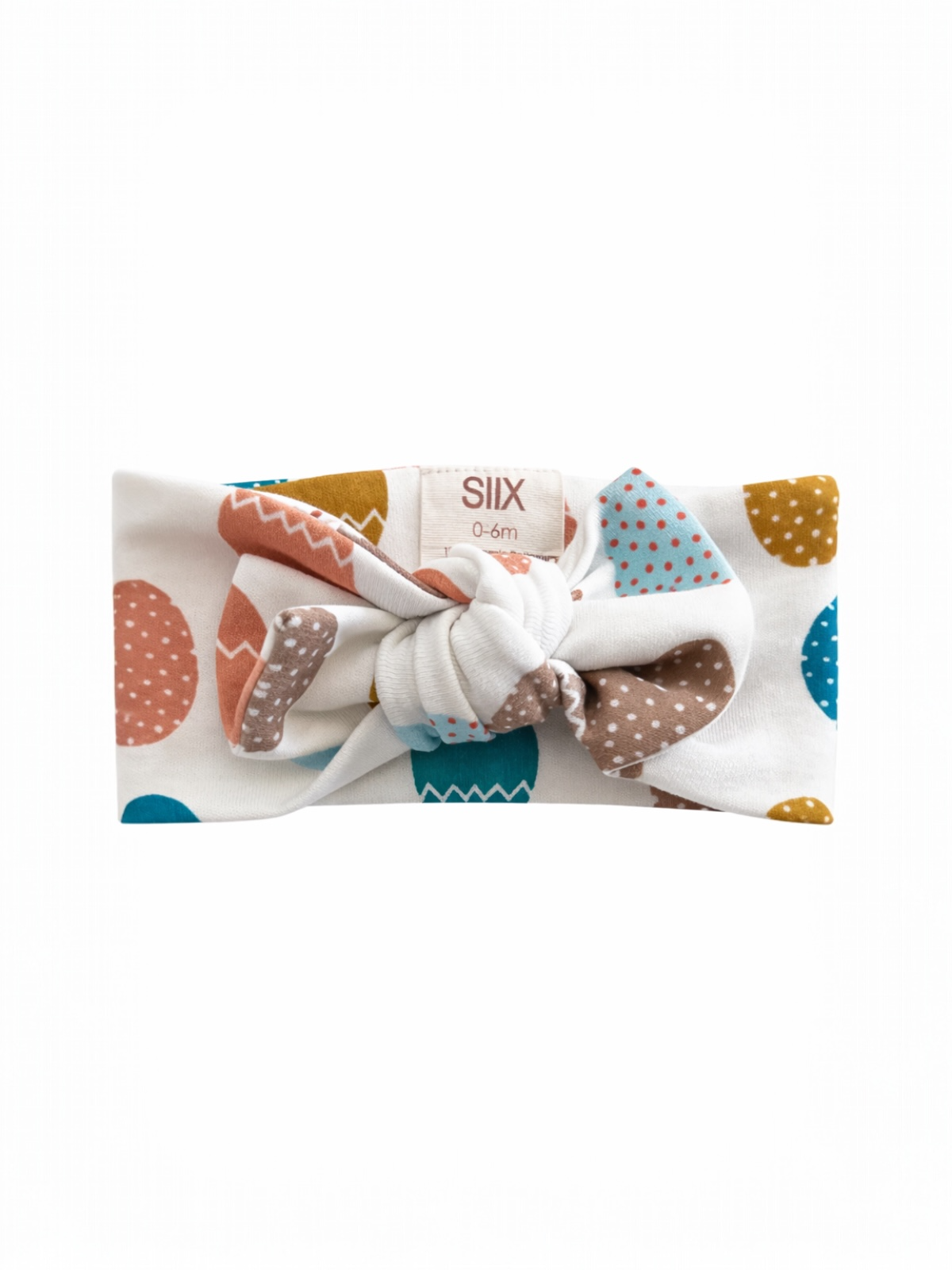 White headband with colorful patterns, featuring a knot at the front, suitable for infants 0-6 months.