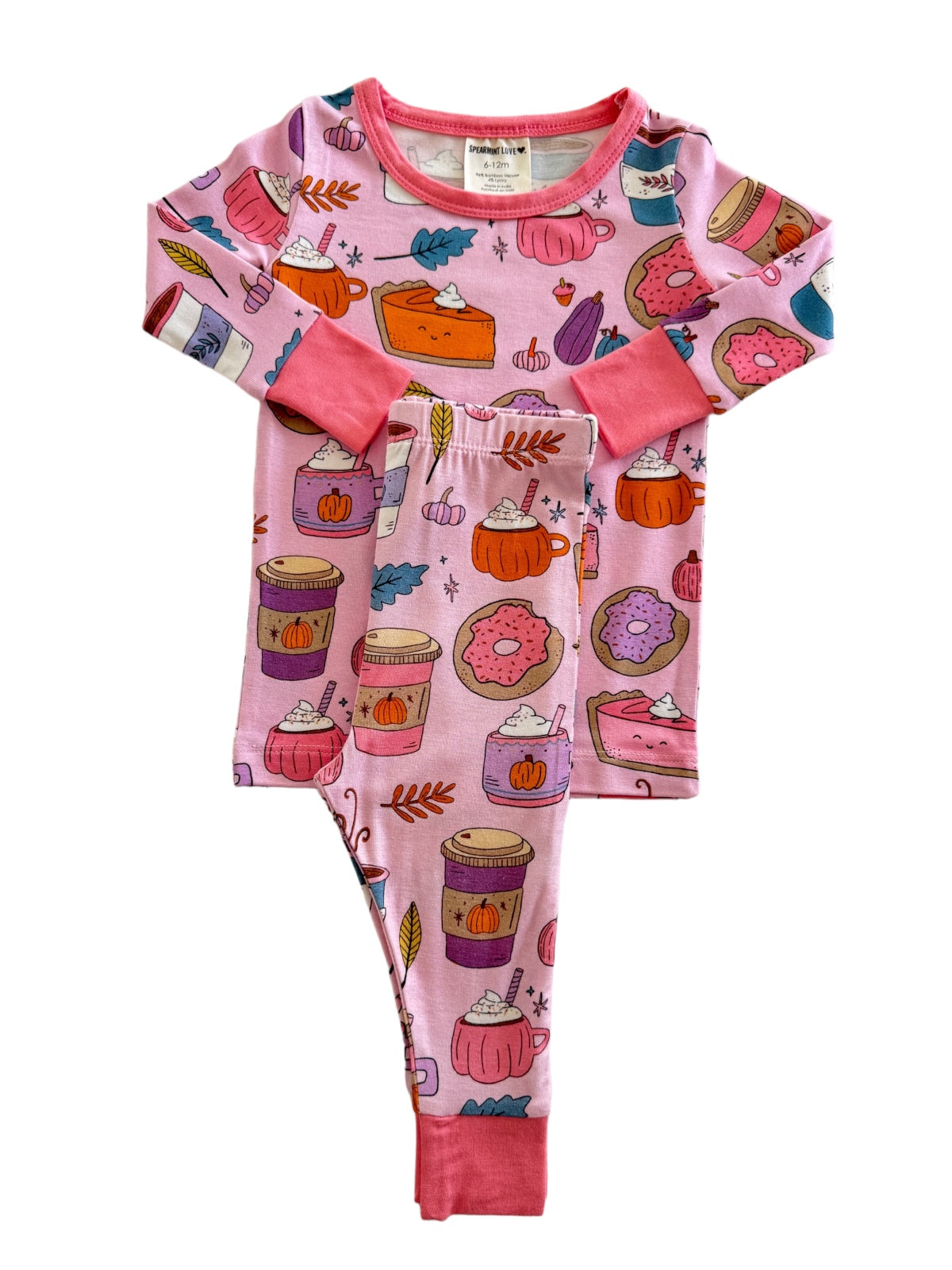 Colorful pink pajamas with playful food and fall-themed patterns, including donuts, pies, and autumn leaves.