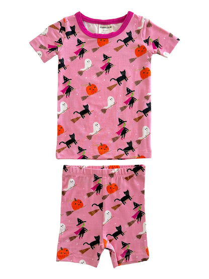 Pink Halloween-themed pajamas featuring ghosts, black cats, witches, and pumpkins on a playful pattern.