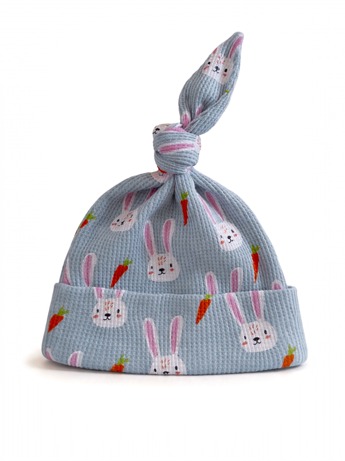 Light blue baby hat with bunny and carrot patterns, featuring a decorative knot at the top.