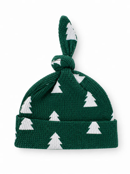 Green knit baby hat with white Christmas tree pattern and knot on top.