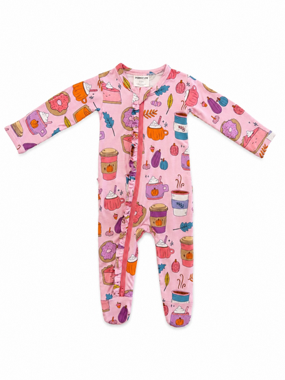 Pink baby onesie featuring colorful illustrations of desserts, drinks, and autumn decorations.