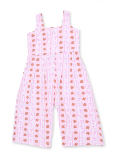 Pink jumpsuit with a playful pattern of brown acorns and pink swirls, featuring wide straps and a relaxed fit.