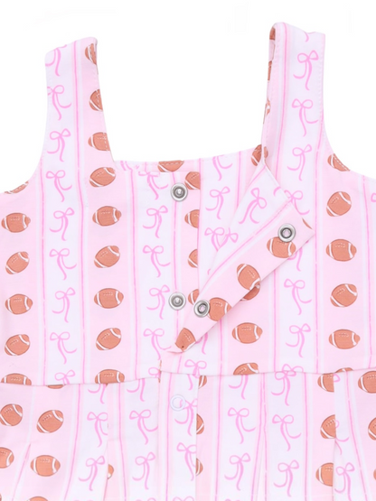 Pink dress featuring a fun football and bow pattern with snap buttons for easy wear.