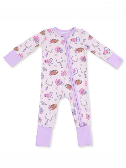 Children's zip-up pajama, light purple with sports and bow patterns. Soft fabric and long sleeves for comfort.