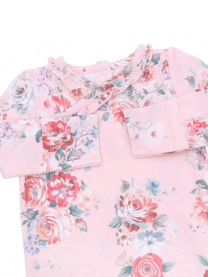 Floral-patterned pink dress with ruffles and button closure, ideal for children’s casual wear.