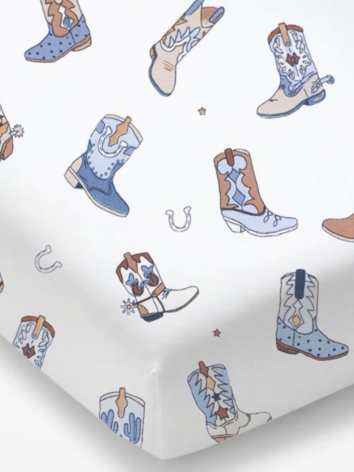Patterned fabric featuring colorful cowboy boots and horseshoes on a white background.